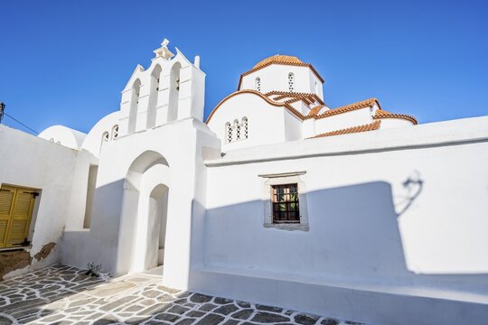 Archway with bells of the Chapel of Agios Antonios and Greek Orthodox Church of Metamorfosi Sotiros, alleys of the village of Marpissa, Paros, Cyclades, Greece
