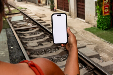 Person holding smartphone at Hanoi Train Street