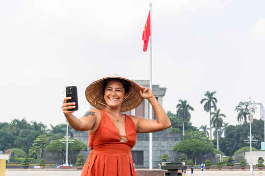 Woman traveling in Hanoi taking selfie at mausoleum