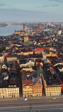 Gamla Stan Old Town in Stockholm, Sweden, historic medieval center with colorful buildings, narrow streets and waterfront surrounded by islands and waterways. Aerial View shows iconic city core
