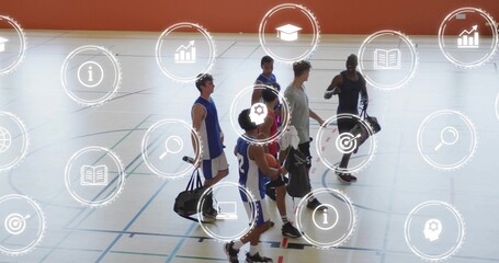 Walking six basketball players on gym court wearing blue jerseys, carrying duffels with HUD