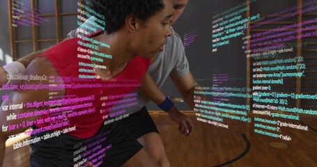Practicing two basketball players leaning and guarding at gym, red and grey shirts, code overlay