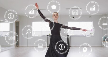 Dancing female holding pose in studio in black leotard and flowing skirt, with digital icons, barre