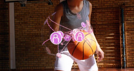 Holding basketball, teen wearing gray tank, white shorts crouching in gym with purple hologram
