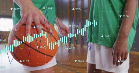 Holding orange basketball, left of duo in green jerseys white shorts on court with chart overlay
