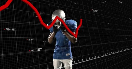 Standing football player adjusting helmet in studio, with blue jersey, pads and red trend line