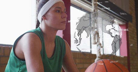 Sitting female wearing green jersey and white headband on gym bench, basketball by knees, AR globe