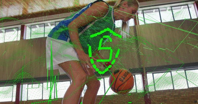 Dribbling woman with basketball bending low in gym, wearing blue jersey white shorts green overlay - Powered by Adobe