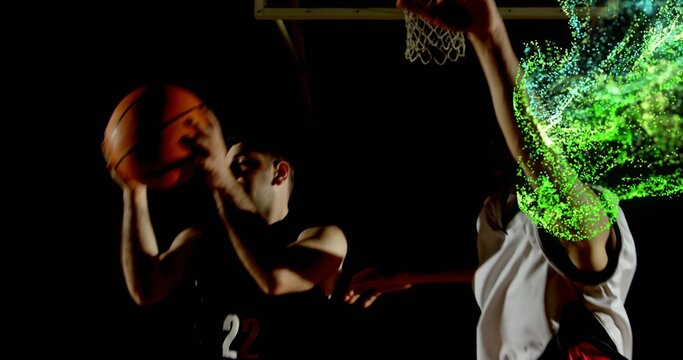 Driving player wearing dark 22 jersey moving toward rim at gym, holding basketball with green trail - Powered by Adobe
