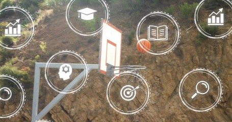 Arcing orange basketball nearing rim while hoop on metal support before rocky hillside, white icons