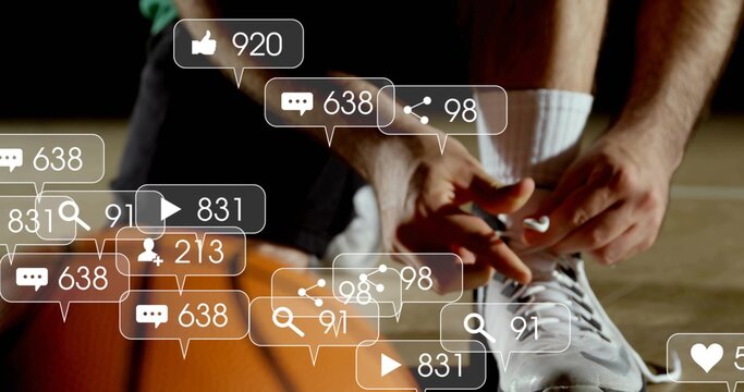 Tying player in shorts tightening lace on white sneaker on basketball court, with social overlays - Powered by Adobe