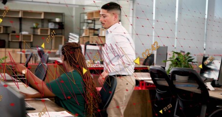 Analyzing green-shirted woman and white-shirted man leaning over monitors at office, red overlay