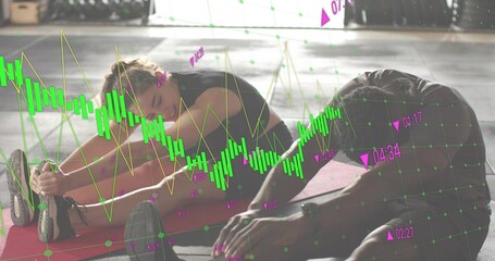 Stretching, two adults in sportswear leaning forward on red mats in gym, showing green candlesticks