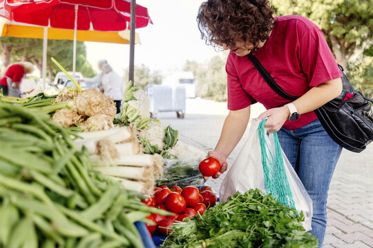 Woman shopping at a bustling outdoor local market
