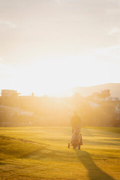 Golfer enjoying a peaceful sunset on the course