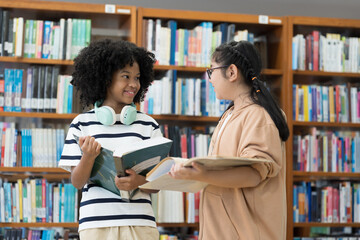 Student and library with books. Happy smiling women students with books in library room at school. Students of diverse nationalities in library. Learning or university education