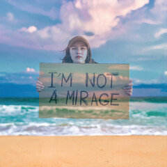 A mirage holding a sign that says &ldquo;I am not a mirage&rdquo;