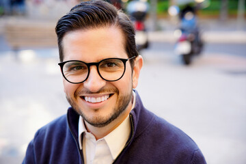 Business professional smiling outdoors in casual attire