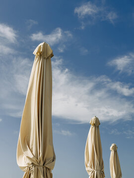 Serene sky with closed beach umbrellas