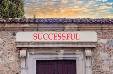 Successful symbol. Concept word Successful on beautiful white marble sign plate. Beautiful ancient stone wall and sunset background. Business successful concept. Copy space.