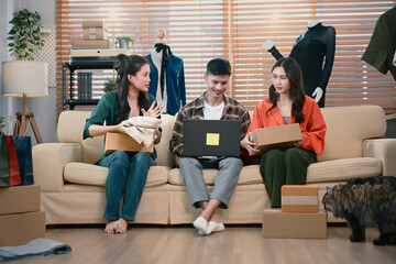 SME team discussing packaging and tracking customer orders at home office, reviewing parcels and logistics workflow together