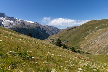 Fototapeta premium Mountain view of the Emparis Plateau in the Arves Massif, Hautes-Alpes, French Alps, featuring rugged peaks and alpine meadows