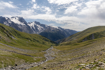 Mountain landscape in the Arves Massif, French Alps, with the iconic La Meije peak in the...