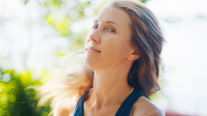 Portrait of the caucasian woman on the natural blurred background