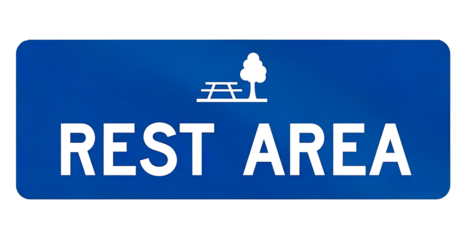 Blue rest area sign with picnic table and tree symbol