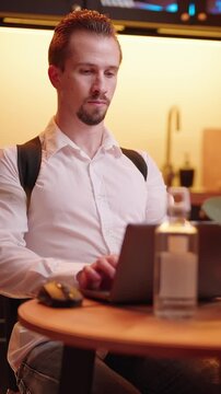 Man behind laptop computer wearing posture correction belt preventing pain