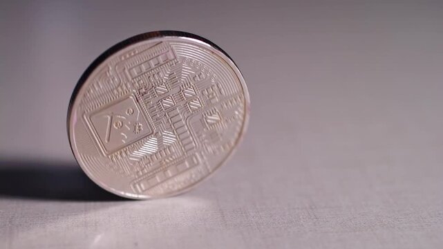 The Bitcoin coins were spinning slowly on the table