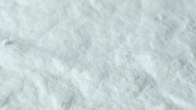 Soda powder heap texture close up. White sodium bicarbonate powder macro.