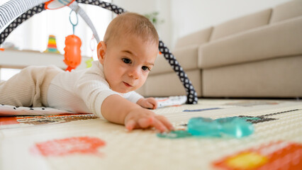 Curiosity of a five month old baby exploring playmat