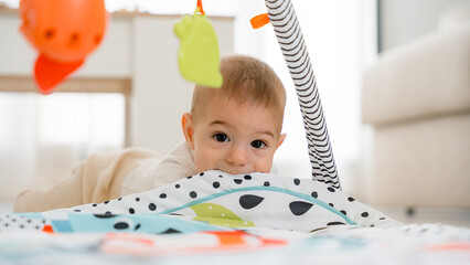 Cute five month old baby enjoying tummy time play