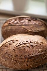 Freshly baked artisan sourdough bread cooling on rack in bright kitchen