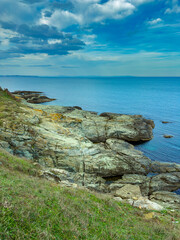 Beautiful coastline with rocky shore and calm sea views under blue sky during daytime in coastal area