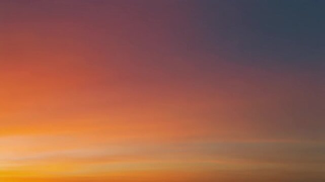 Abstract gradient sky of vibrant warm orange and yellow merging into tranquil cool purple and deep blue, capturing the natural beauty of dawn or dusk