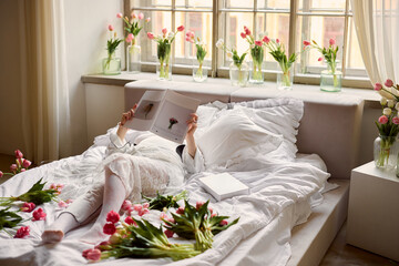 Peaceful waking scene featuring sunlit room decorated with tulips and soft spring atmosphere