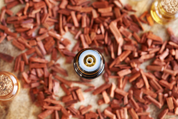 A brown bottle of aromatherapy essential oil with red sandalwood