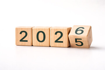 Year change concept with wooden blocks showing 2026 replacing 2025 isolated on white background business planning theme