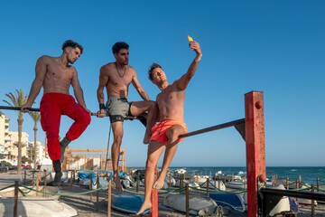 Young men doing selfie during calisthenics training