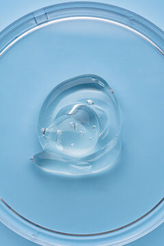 Clear cosmetic gel texture on blue surface
