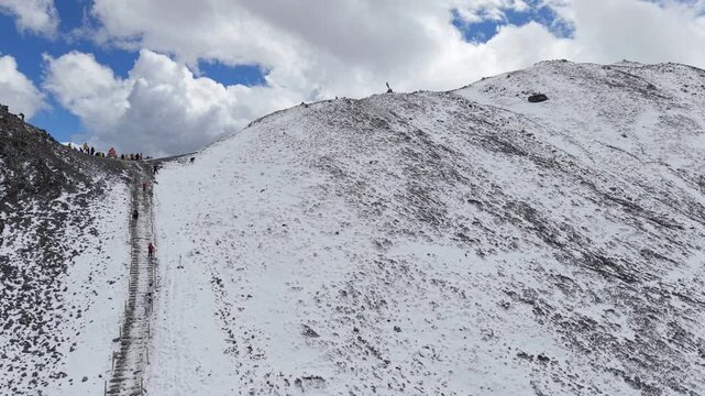 Drone Reveal Shot of Yala Snow Mountain in Winter