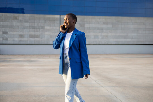 Confident African businesswoman talking on phone