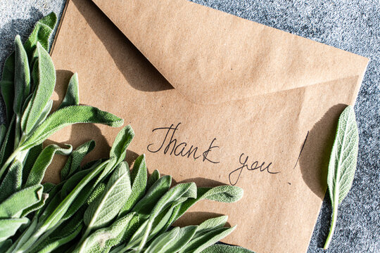 Sage leaves by a thank you envelope