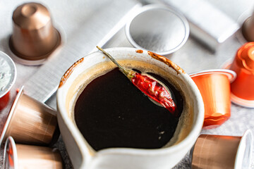 Espresso coffee with chili pepper in a cup