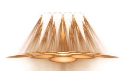 Golden light rays shining through a metal object in an indoor setting