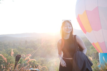 A woman is standing on a hill with a pink. travel mountain concept.
