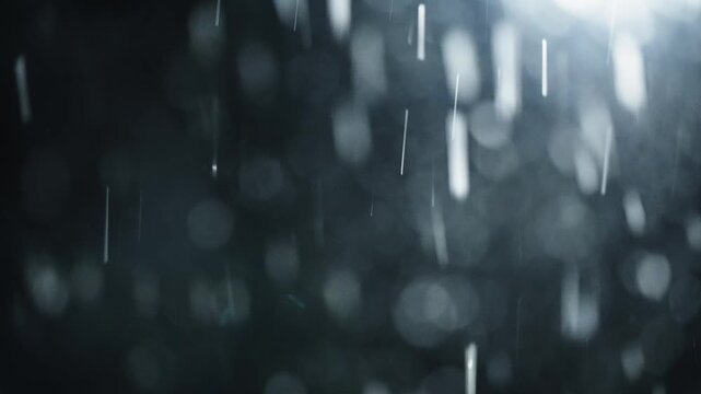 Windblown snowflakes streak across a dark night, captured closeup with soft bokeh and motion blur, revealing a cinematic winter blizzard of drifting ice crystals.