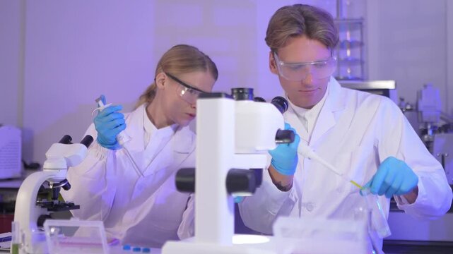 Scientists conduct experiments in laboratory with microscopes and samples during the day
